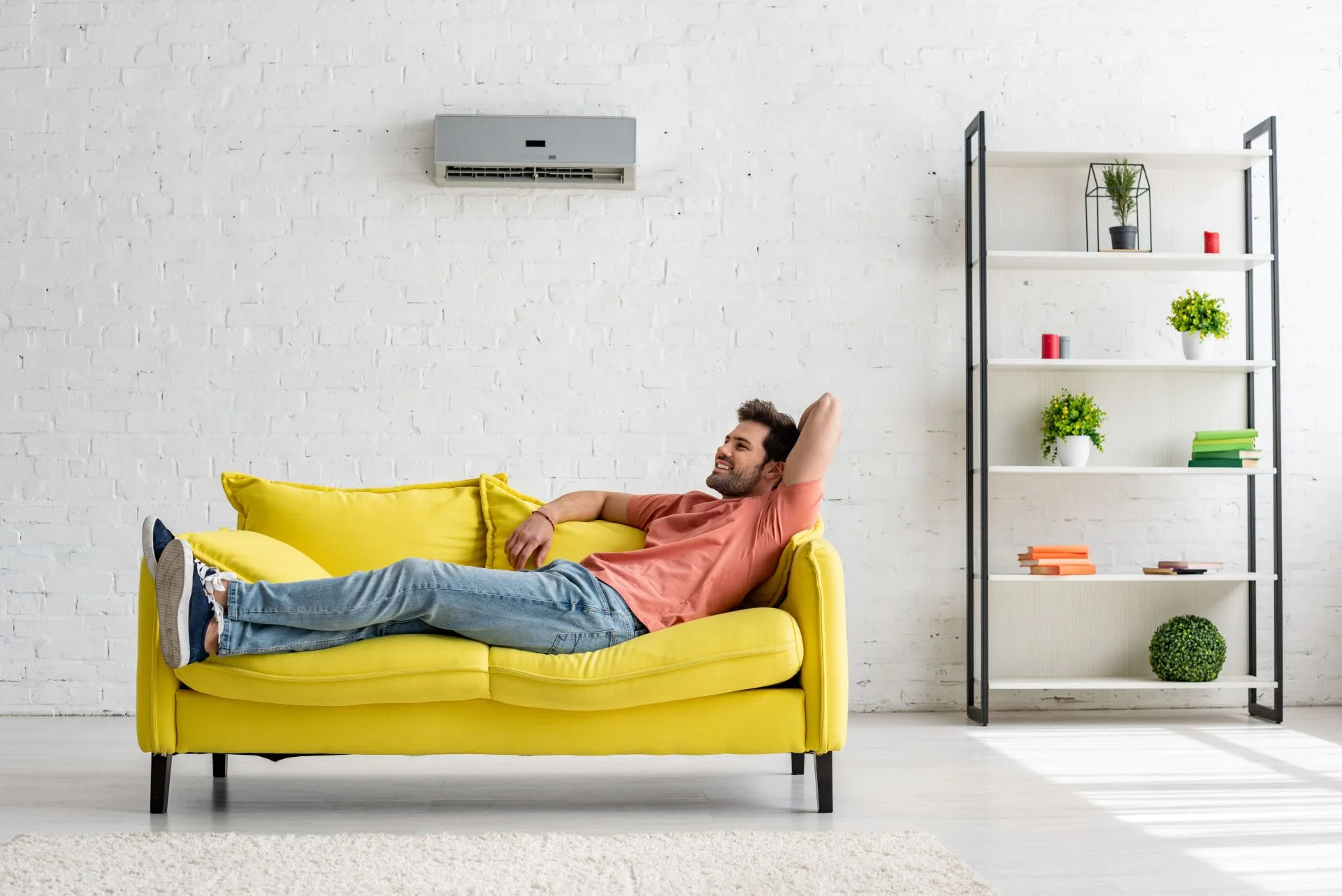 Home - Handsomesmilingmanlyingonyellowsofaunderai20210831033630utc1 - Promise Home Comfort